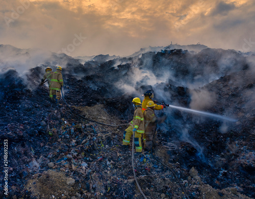 Aerial view of firefighters battling a large fire at the Vertedero Duquesa landfill with thick smoke rising into the sky in Pantoja, Santo Domingo, Dominican Republic.