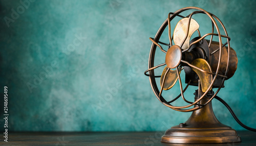 Vintage Electric Fan on a Rustic Teal Backdrop.