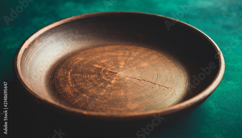 Minimal Empty Ceramic Bowl on Green Fabric.