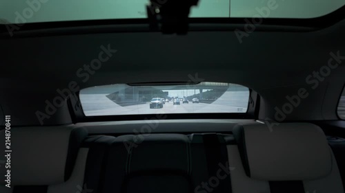 Rear seat view through windshield at trailing traffic on multi-lane highway