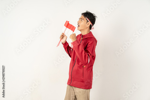 Canvas Print Indonesian man singing national anthem passionately holding small red white flag