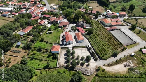 Aerial view of the Igreja Paroquial de Freixo surrounded by rural fields, vineyards, and traditional houses in Freixo, Viana do Castelo, Portugal.