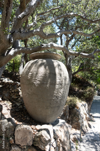Large Stone Public art Urn in Thousand Oaks, Berkeley, California. Indian Rock Trail Large weathered stone garden urn surrounded by mature oak trees and natural rock landscaping in the Thousand Oaks