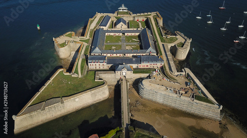 Aerial view of the Vauban Citadelle de Port-Louis, a historic star-shaped fortress surrounded by water with sailboats nearby in Port-Louis, Bretagne, France.