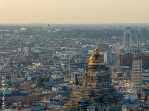Aerial view of the Palais de Justice with its golden dome overlooking the urban skyline of Brussels at sunset, with the Atomium visible in the distance in Brussels, Brussels, Belgium.