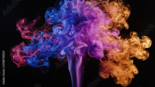 Abstract colorful smoke plumes swirl and expand in dark space, creating dynamic visual effects with red, blue, and orange hues