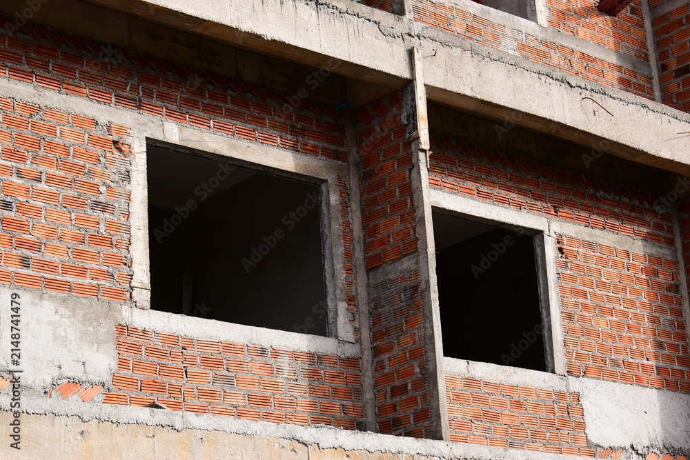Fototapeta premium exterior view of brick house under construction with concrete structure