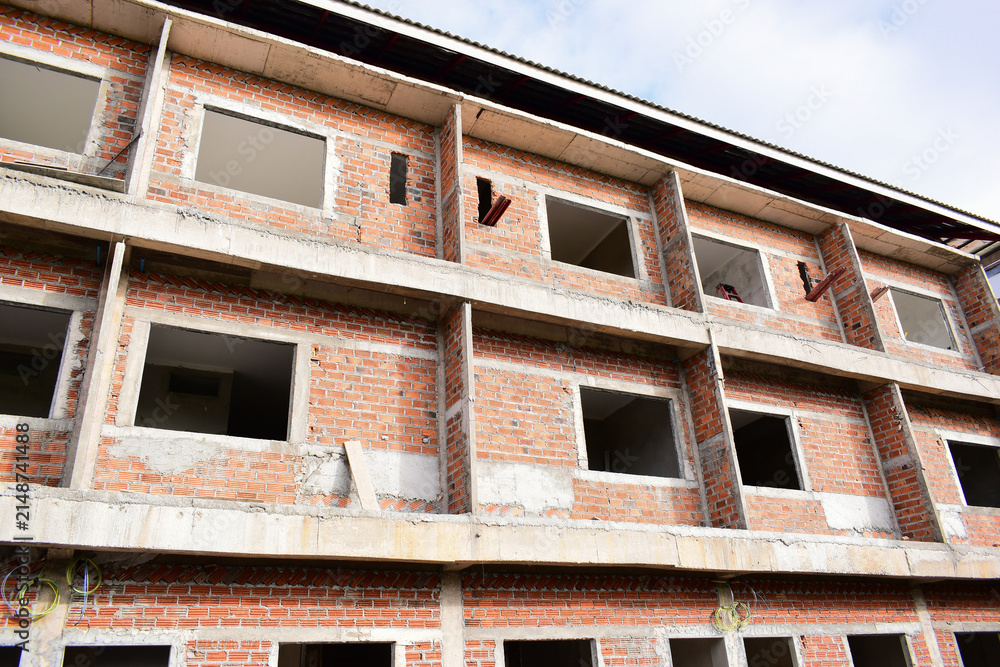 Fototapeta premium exterior view of brick house under construction with concrete structure