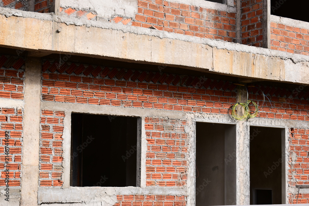 Fototapeta premium exterior view of brick house under construction with concrete structure