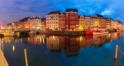 Nyhavn harbor panorama with colorful waterfront buildings at dawn in Copenhagen Denmark