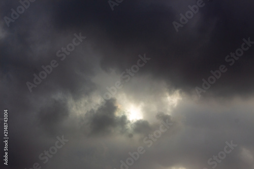 Konstfotografi Dramatic storm clouds with sunlight breaking through, dark overcast sky backgrou