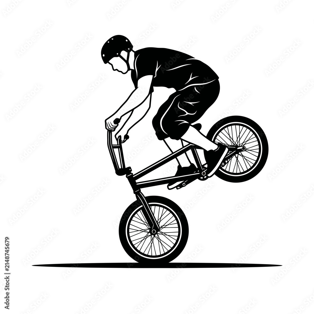Fototapeta premium BMX rider performing a wheelie trick. The rider is wearing a helmet and shorts, and is on a bicycle with thin tires.