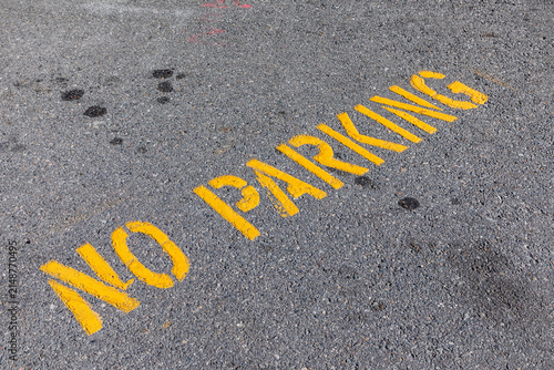 no parking signage in yellow painted at the street