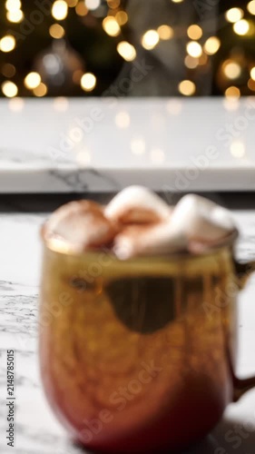 Steaming Hot Chocolate With Marshmallows in a Golden Mug on a Marble Surface