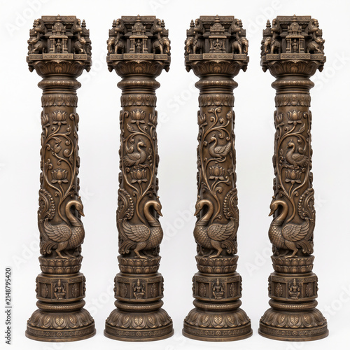 Intricately carved stone temple pillars with ornamental bird sculptures and traditional architectural relief details