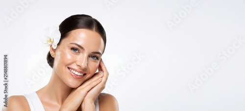 Smiling Woman with White Flower in Hair Posing