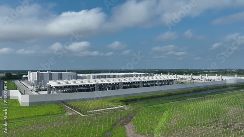 Modern AI data center campus with advanced cooling infrastructure as a drone flies toward the facility, showcasing hyperscale cloud computing and digital infrastructure in Wisconsin.

