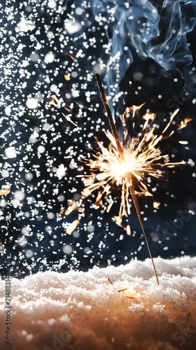 Burning Sparkler Emitting Bright Sparks and Smoke Over Fresh Snow in Winter Night