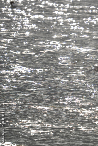 Sunlight sparkling across a rippling water surface