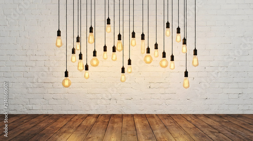 Interior design background with hanging vintage lightbulbs against white painted brick wall texture