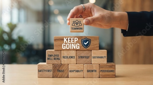Stacked cardboard boxes with motivational words for teamwork