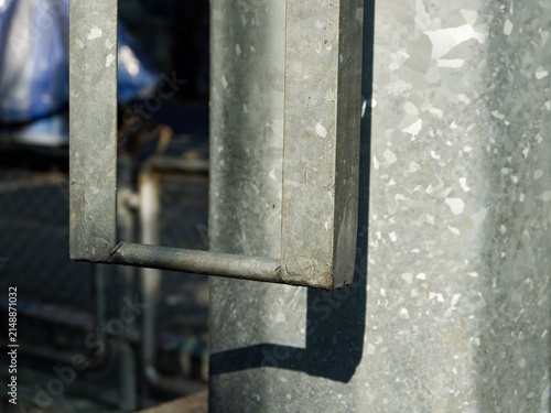 Photography Industrial steel pole structure with integrated access ladder rungs for outdoor maintenance work