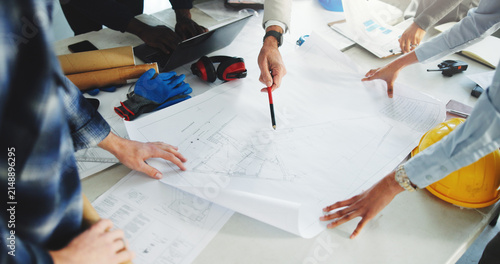 Architect, team and hands in office with blueprint, brainstorming and technical drawing of building. People, meeting and floor plan in workplace for construction guide, layout design or architecture.
