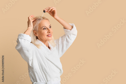 Mature woman in bathrobe ap...