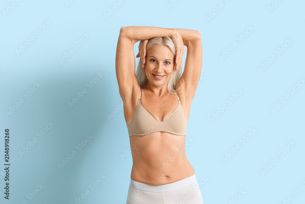 Fototapeta premium Body positive mature woman in underwear on blue background