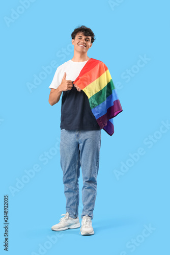 Canvastavla Young man with LGBT flag showing thumb-up on blue background