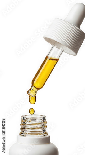 Glass dropper with liquid serum isolated on transparent background
