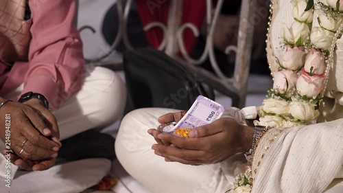 Hands Exchanging Currency During Traditional Indian Wedding Ritual