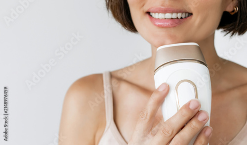 Obraz na plátne Cropped View of Smiling Female Using Compact IPL Laser Device for Precise Chin H