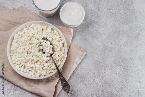 Rustic cottage cheese in a plate on the table