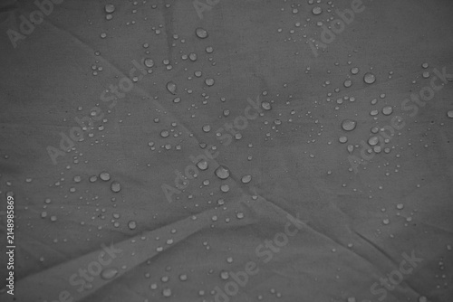 Cuadro en lienzo Water drops on grey waterproof fabric surface background close up