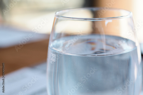Принти на полотні Close-up view of a clear glass filled with still water on a table
