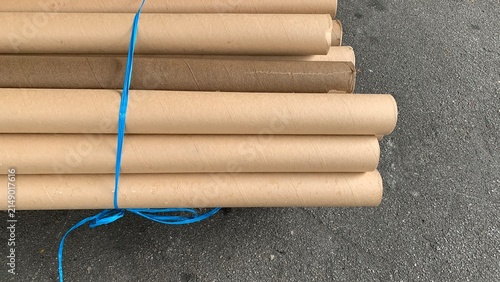 Bundled cardboard paper cores secured with plastic strapping, prepared for storage, recycling, or manufacturing use