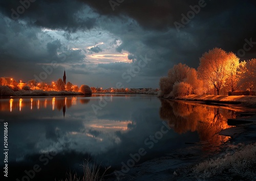Nighttime Serenity - A Tranquil River Reflecting Illuminated Trees and Cityscape.