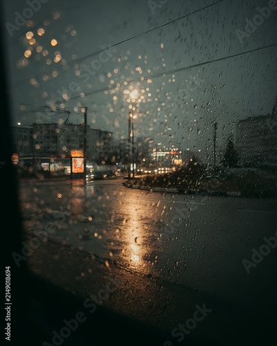 Rainy Cityscape - Reflections and Atmospheric Mood Through a Window.