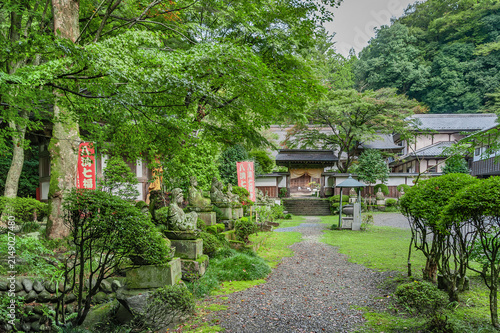 Foto 乾徳寺の境内に並ぶ石仏群と緑豊かな参道/Stone Statues and Greenery in the Precincts of Kentokuji Tem