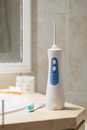 Tools for cleaning teeth in the bathroom. Portable mouth irrigator and dental floss