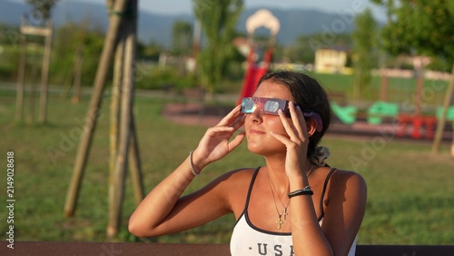 Cuadro en lienzo Young Caucasian woman watching total solar eclipse safely in natural park settin