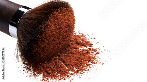 Quadro su tela Makeup brush with brown powder falling onto white surface