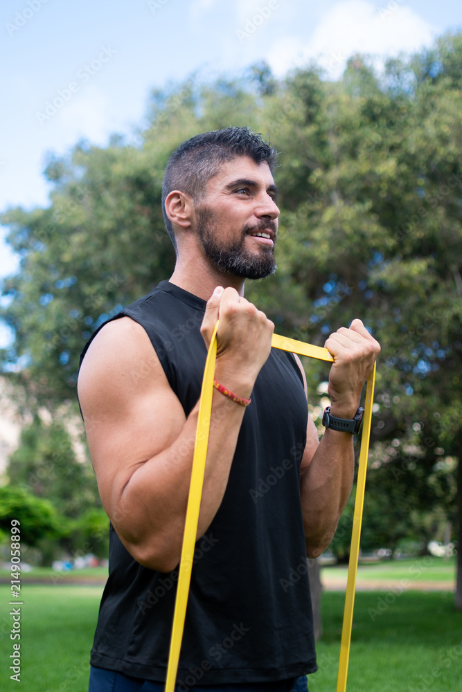 Fototapeta premium Man doing bicep curl with resistance band