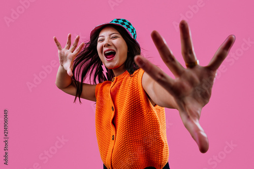 Cuadro en lienzo Young woman playfully reaching out with hands to camera