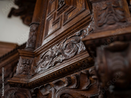 Fotografie Carved oak obelisk finial with a geometric fret panel and foliate brackets in a historic church, Renaissance woodwork craftsmanship