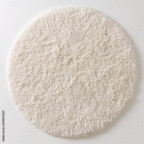 Fluffy round cream shag rug sits on white background.