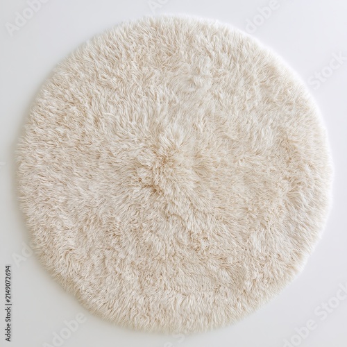 Fluffy round cream shag rug sits on white background.