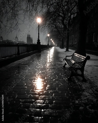 Eerie Night Walk - A Bench Under the Glow of Streetlights.