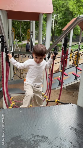 Boy climbing playground ropes